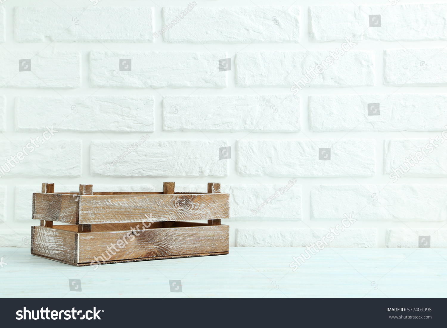 Wooden crate on the brick wall background #577409998