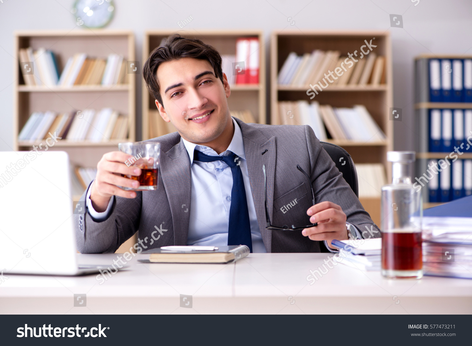 Young businessman drinking from stress #577473211