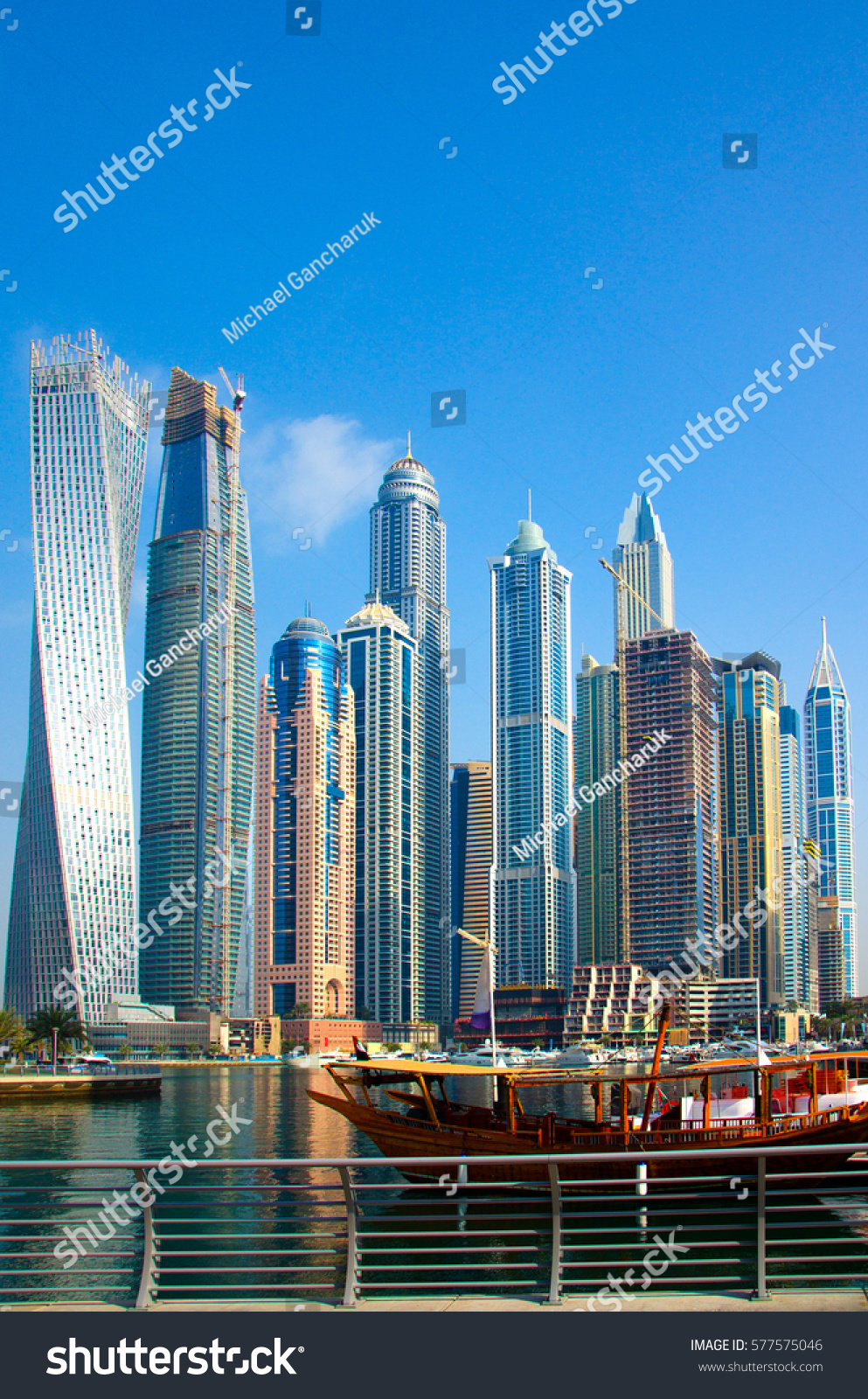 Traditional Arabic wooden ship (Abra) for tourists against the background of skyscrapers, Marina Walk #577575046
