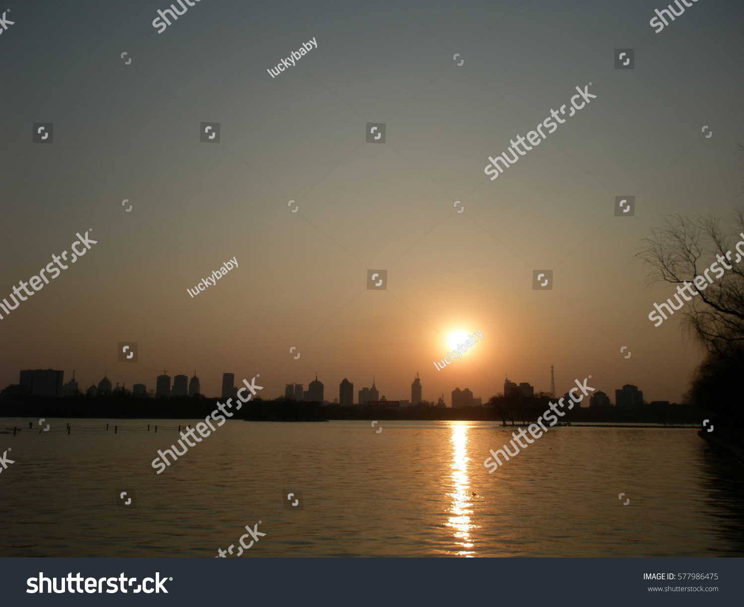 Warm winter sunset over lake at Jinan, Shandong province, China #577986475