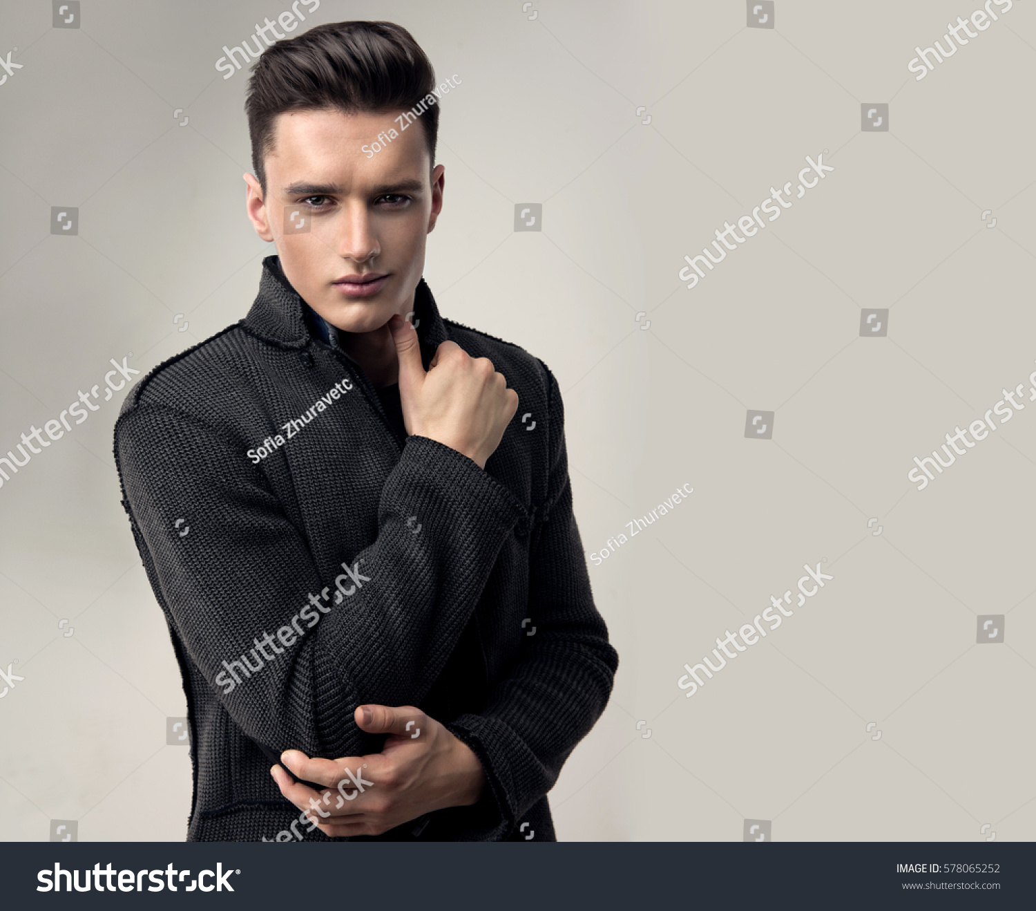 Fashion portrait of a handsome man with trendy hairstyle in a stylish jacket .  #578065252