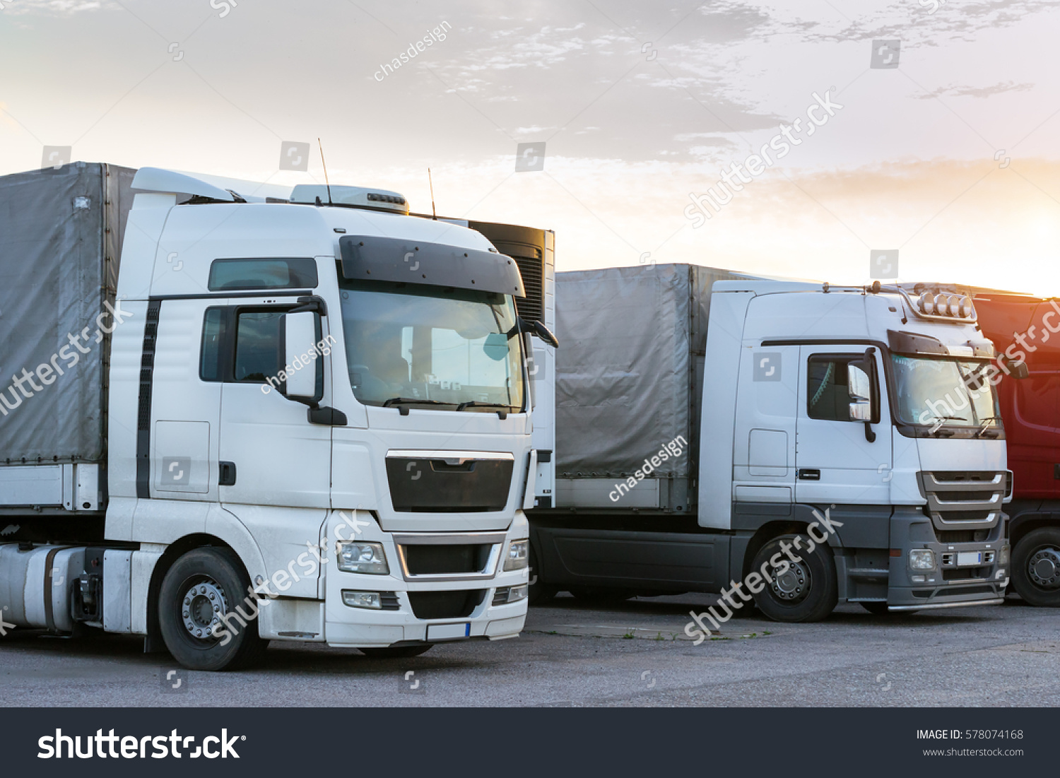 Narva, Estonia - August 20, 2016: Heavy trucks loaded with goods trailers, parked in waiting area on state border crossing. International hard transportation and logistics. Transport infrastructure #578074168