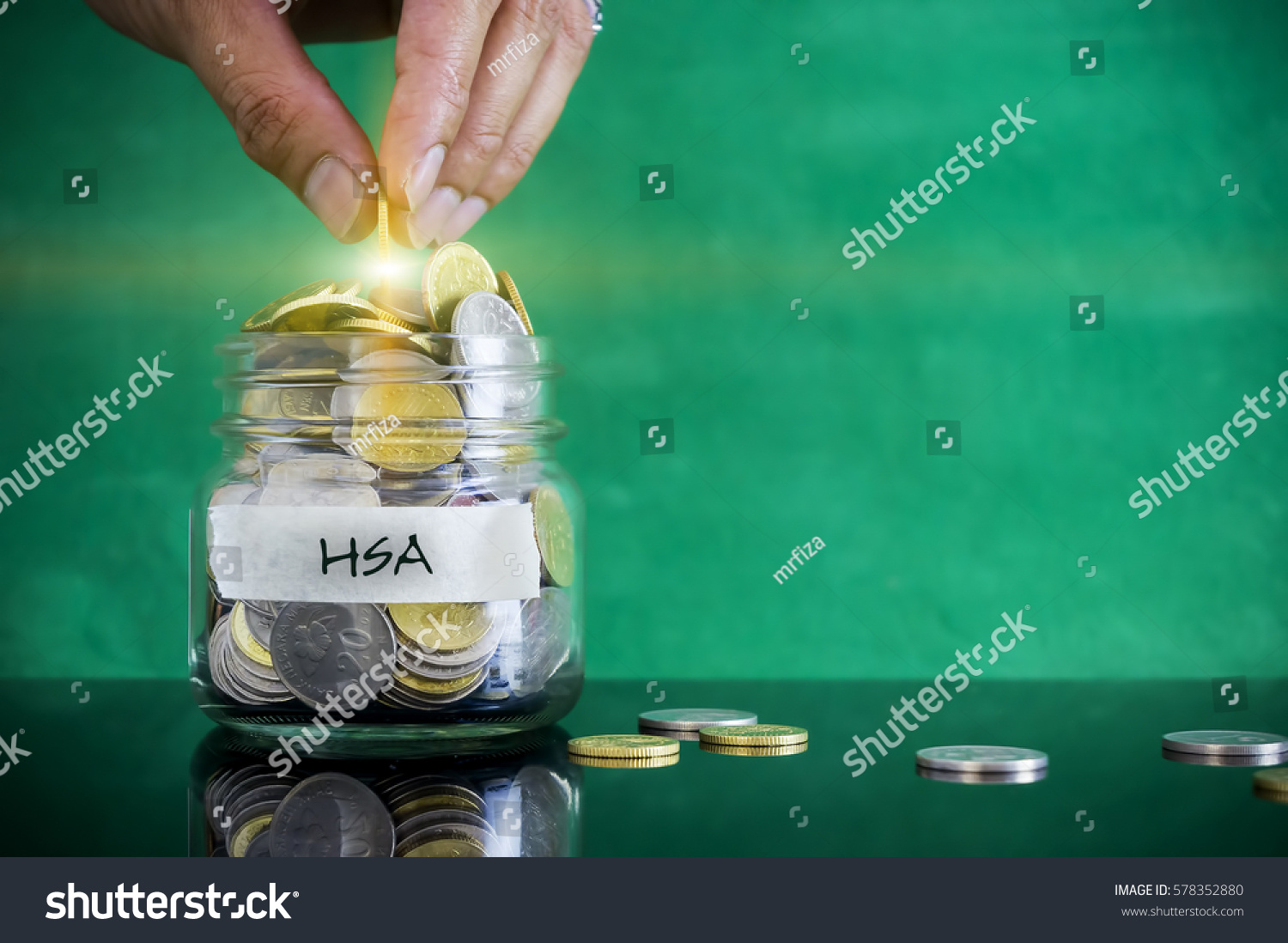 Preparation for future and financial concept. Coins in glass jar with HSA (Health Saving Account) label with light flare. Malaysia coins. #578352880