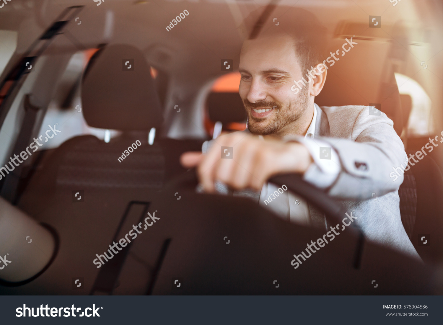 Handsome businessman driving car before buying #578904586