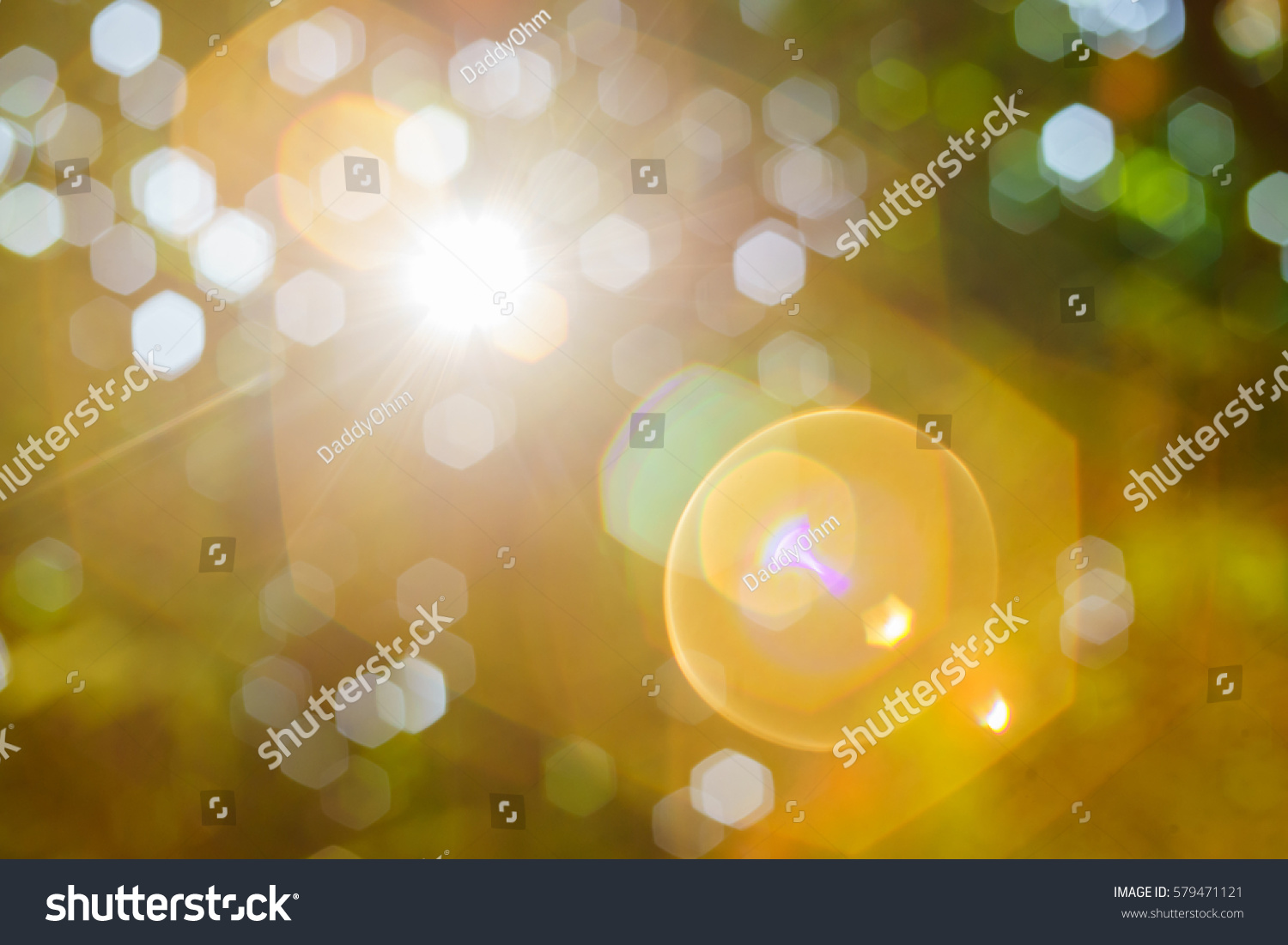 Nature bokeh background and a bright sun light flair. #579471121
