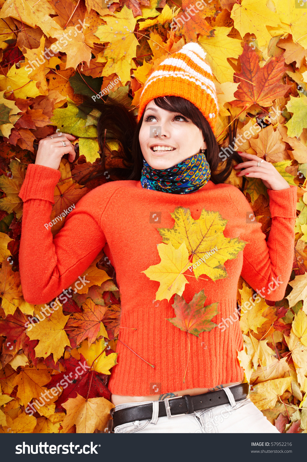 Young woman in autumn orange leaves. Outdoor. #57952216