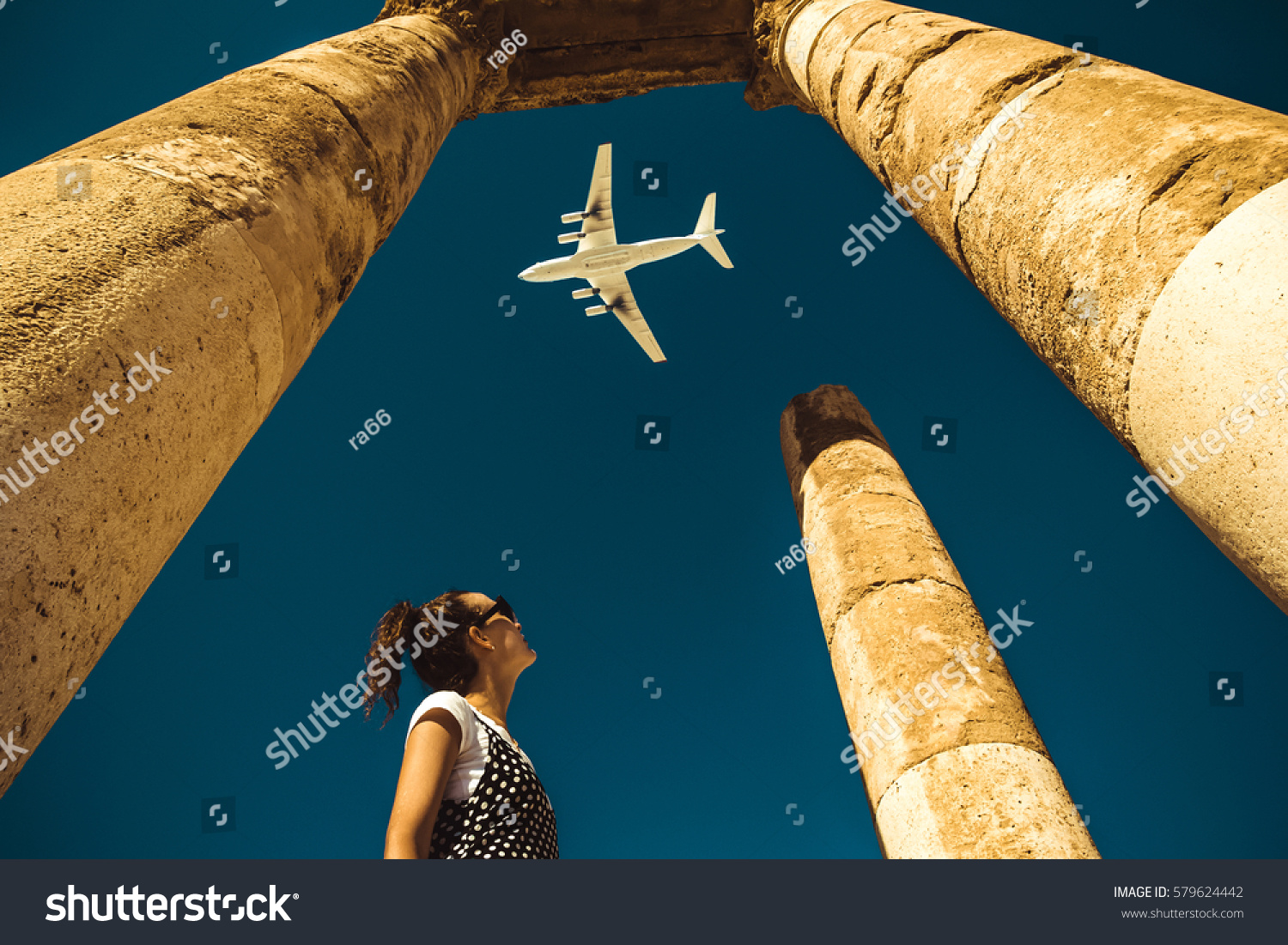  Young woman look at airplane dreaming about vacation. Explore the world. Export concept. Time to travel. Freedom life. Independent person. Tourism and transportation industry. Spirit of adventure. #579624442