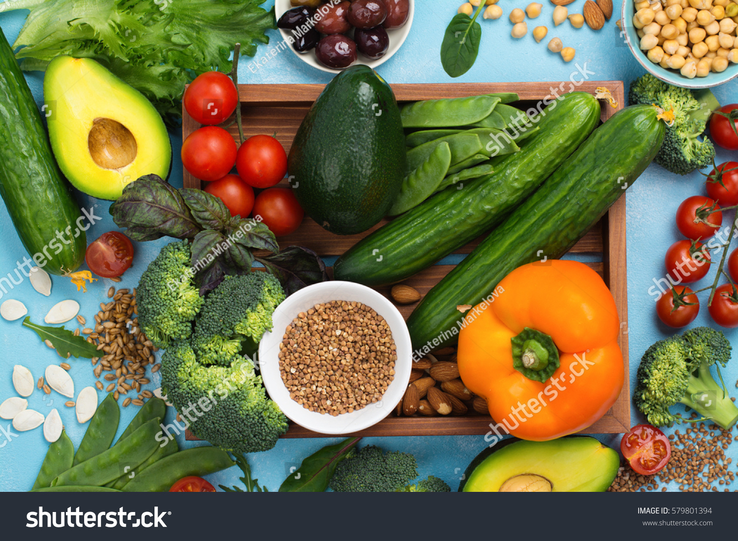 Healthy diet concept. Olives, lettuce, tomato, chickpeas, buckwheat on summer background. Space for text #579801394