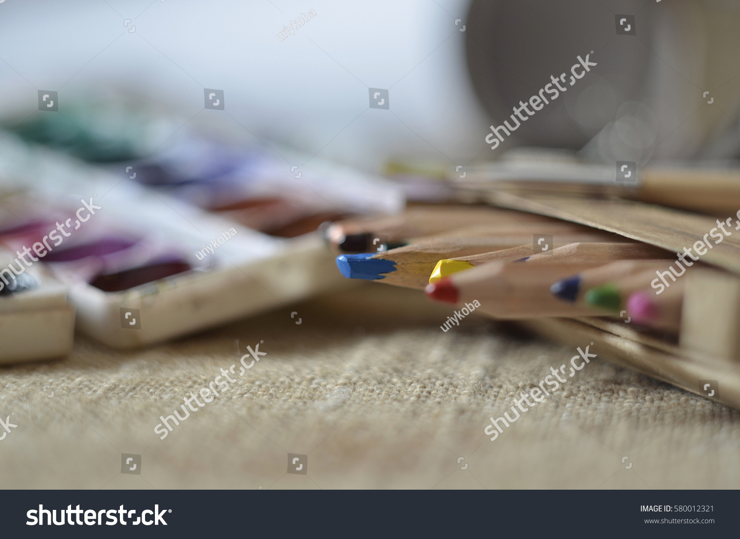 art supplies lie on the rough cloth  #580012321