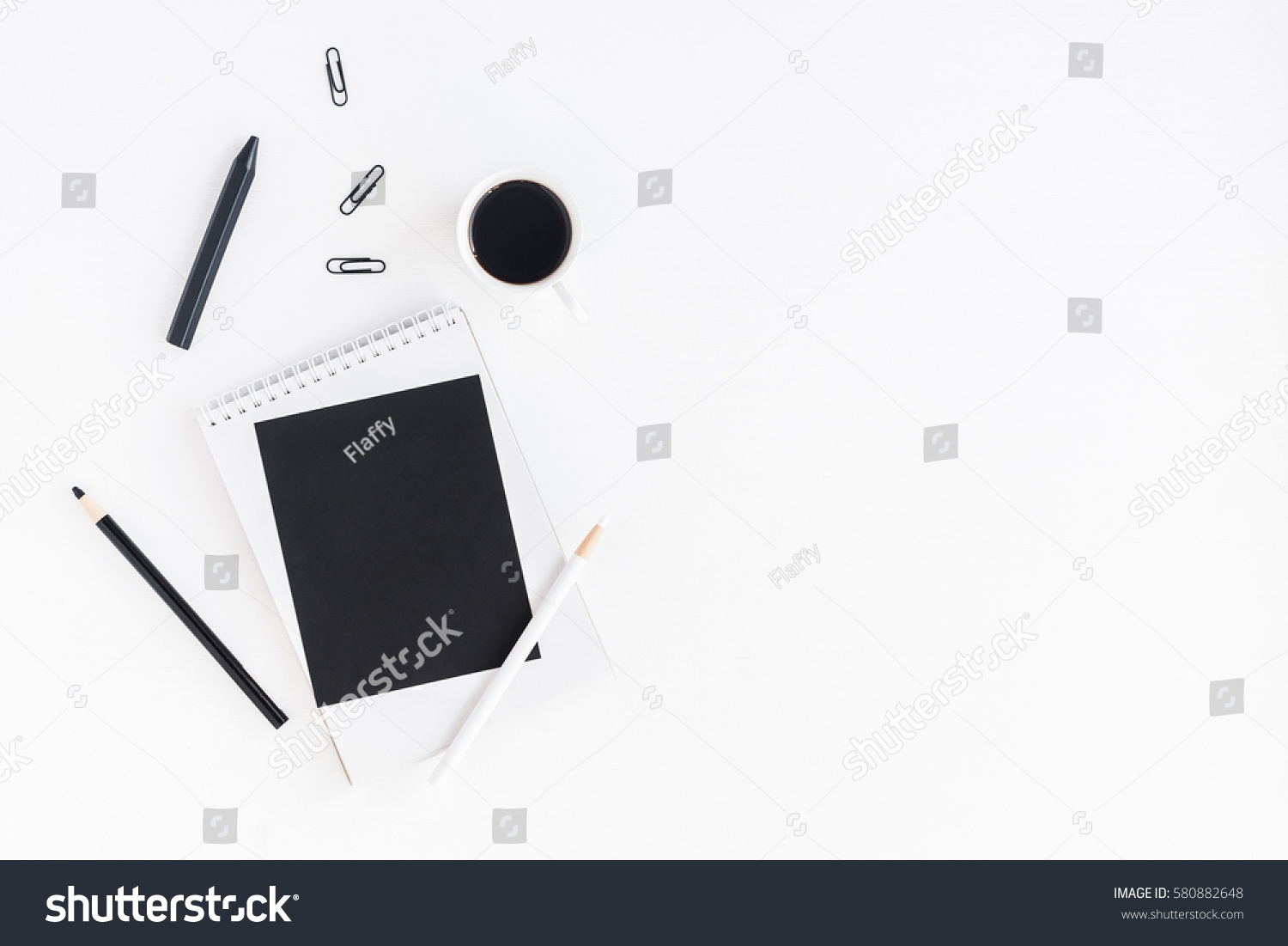 Stylish workspace with notebook, cup of coffee, paper blank, pencils. Business concept.  Flat lay, top view. #580882648