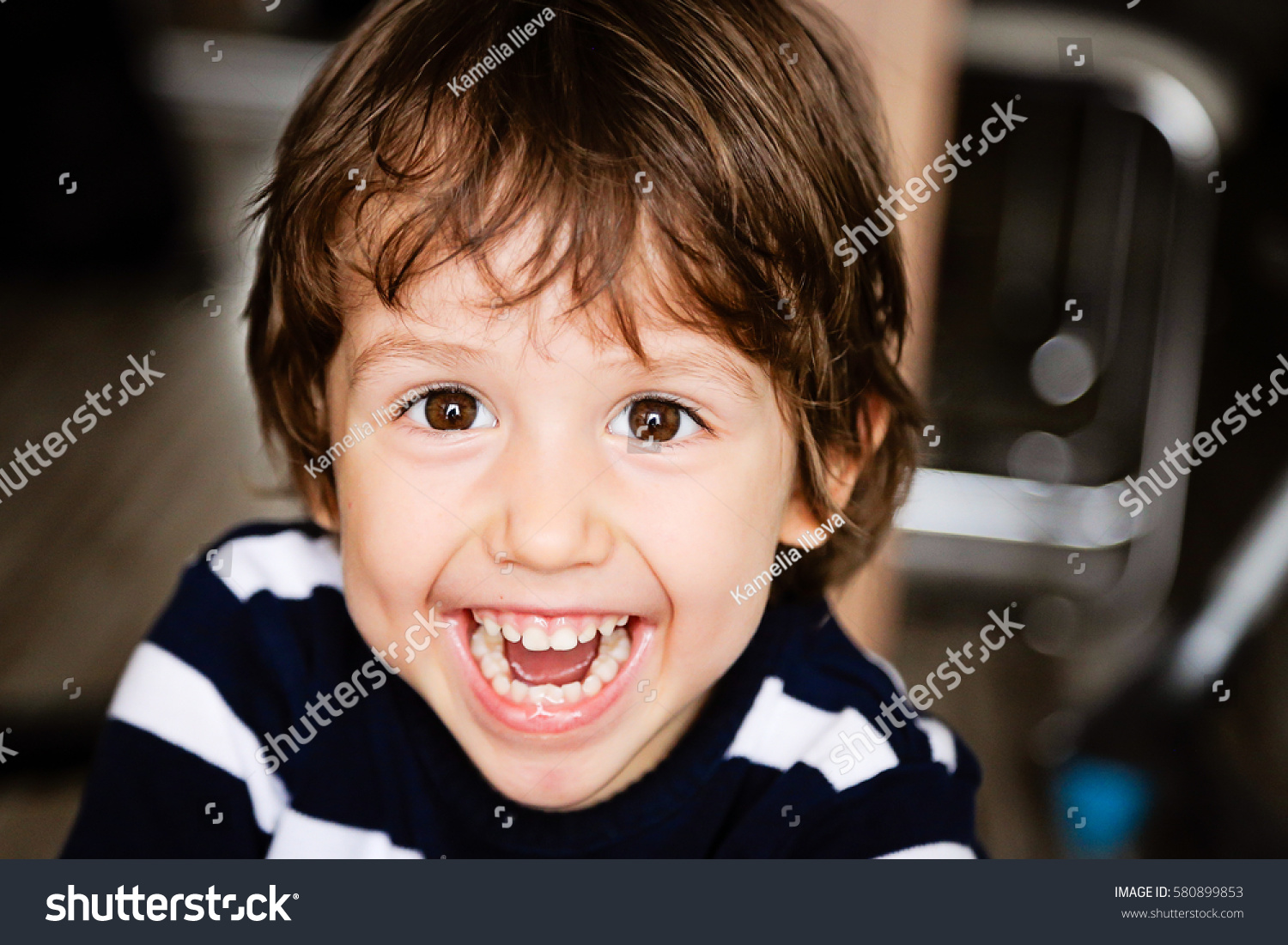Portrait of happy child toddler boy smiling and laughing close up #580899853