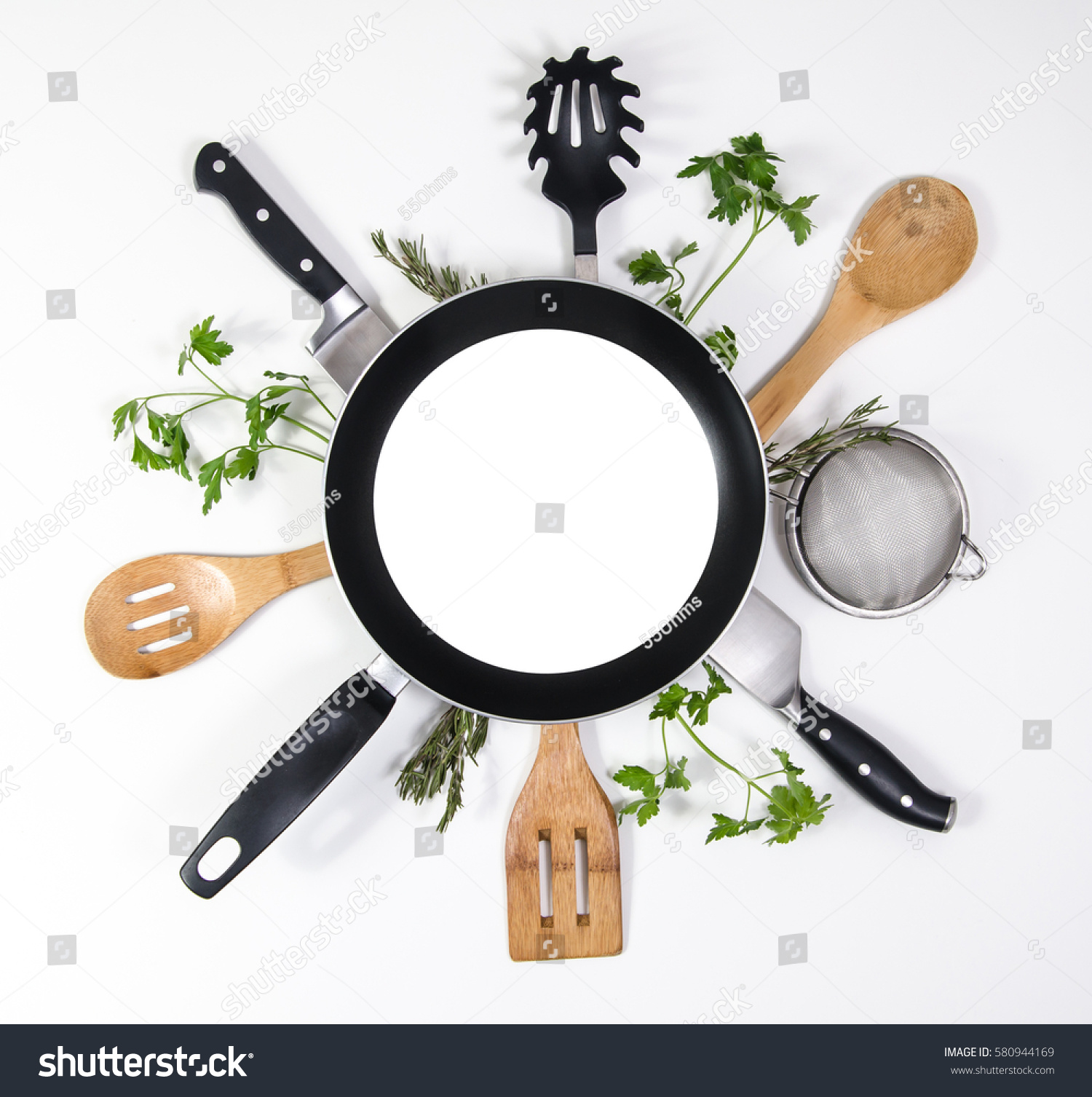 Concept layout for restaurant brochure, menus, presentation or advertising. Frying pan with blank copy space or room for text on top of kitchen utensils and parsley leaves. White background. #580944169