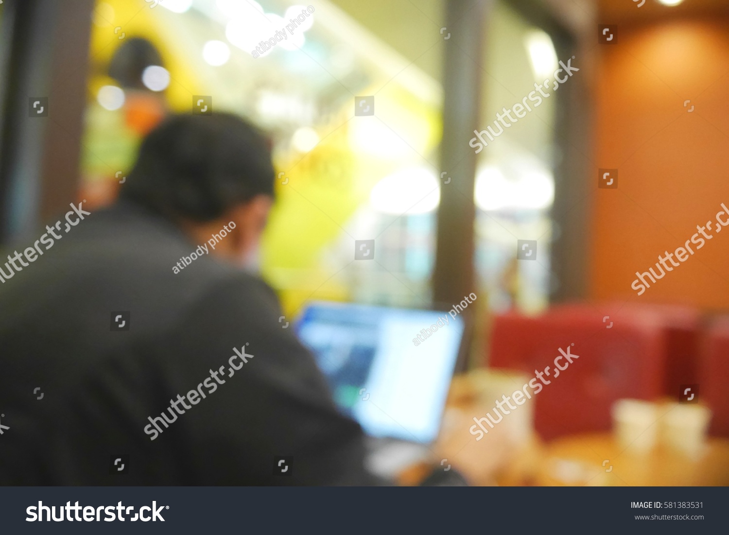 Picture blurred  for background abstract and can be illustration to article of Business man working laptop in coffee shop #581383531