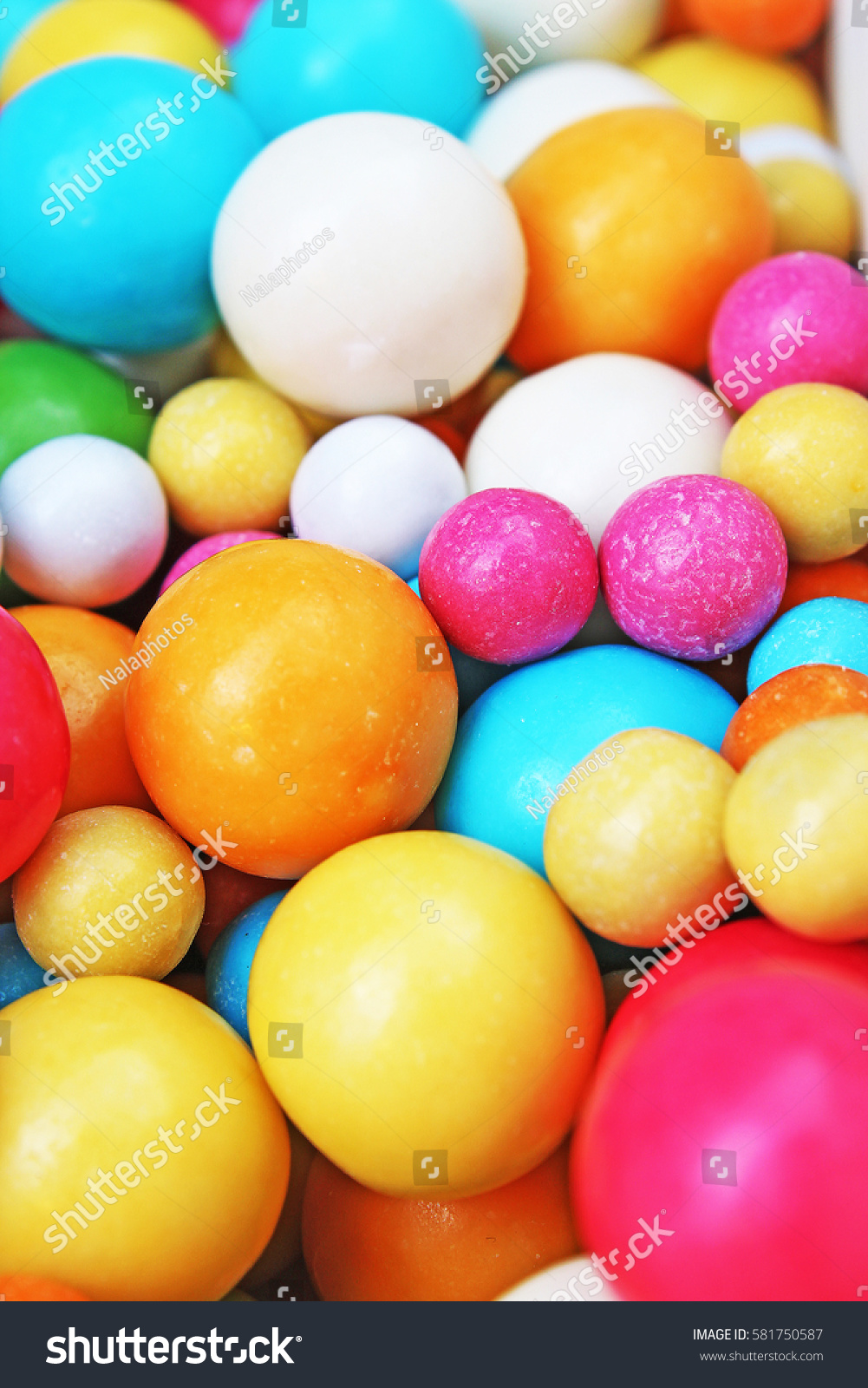 Bubble gum chewing gum texture. Rainbow multicolored gumballs chewing gums as background. Round sugar coated candy bonbon bubblegum texture. Colorful multicolor bubblegums wallpaper. Candy background #581750587