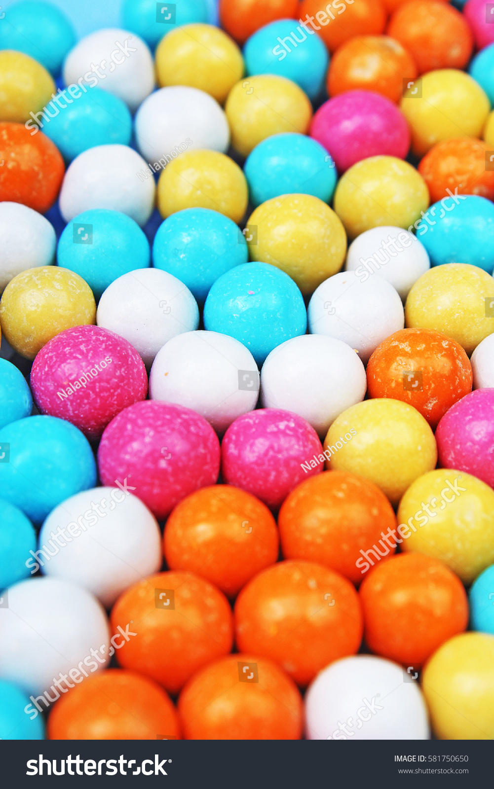 Bubble gum chewing gum texture. Rainbow multicolored gumballs chewing gums as background. Round sugar coated candy bonbon bubblegum texture. Colorful multicolor bubblegums wallpaper. Candy background #581750650