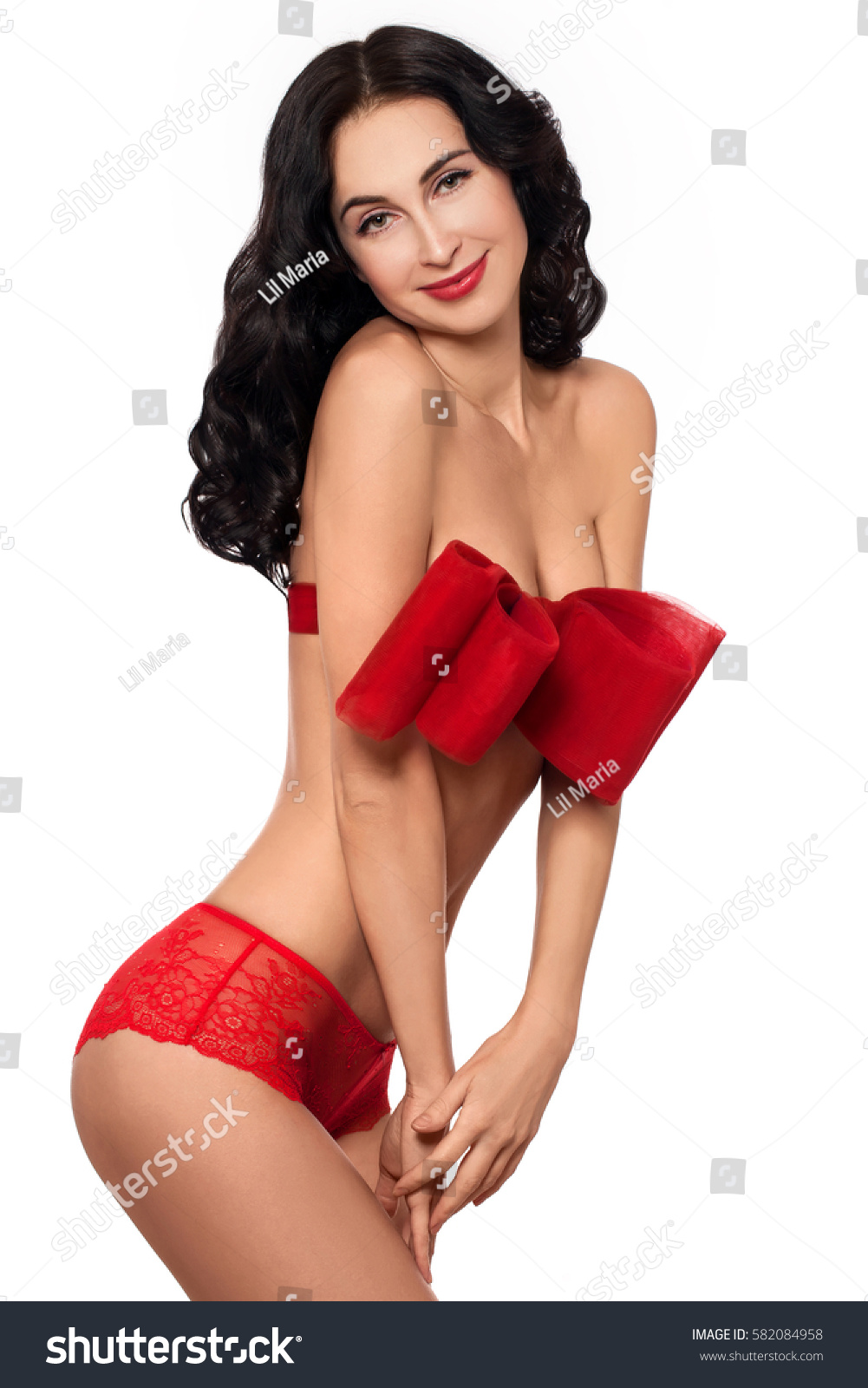 Sexy young girl with big red bow. Beautiful - Royalty Free Stock