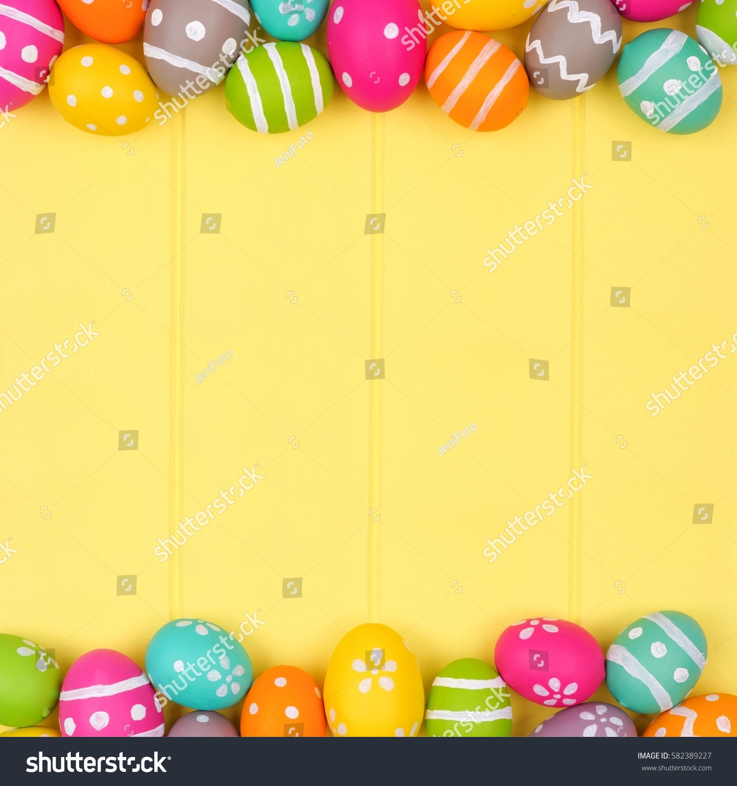 Colorful Easter egg double border against a yellow wood background #582389227