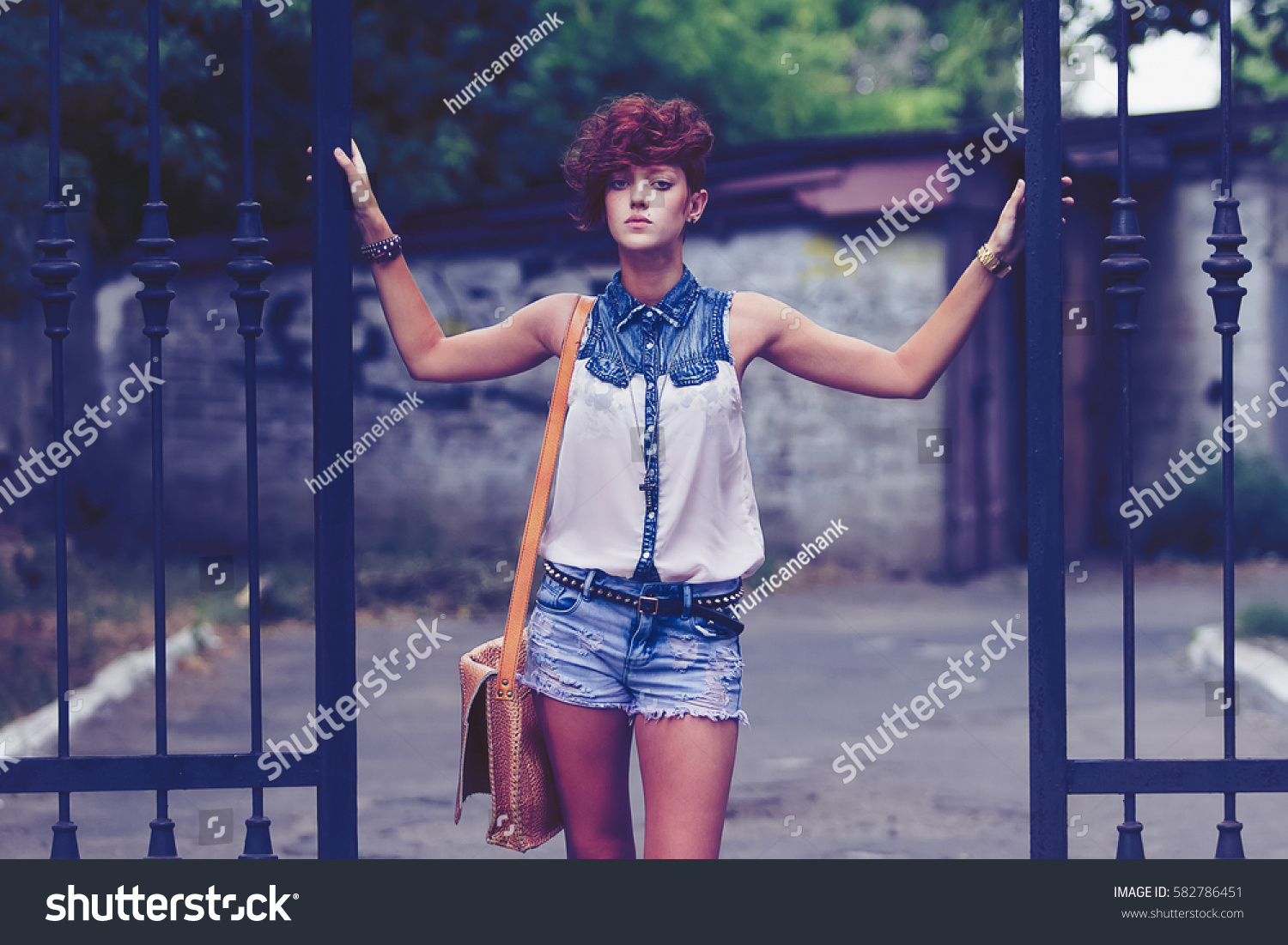 Street fashion model girl posing outdoor in summer.Cool skinny female hair model with modern hairstyle.Fashionable young white woman pose.Beautiful hairstyle for youth #582786451