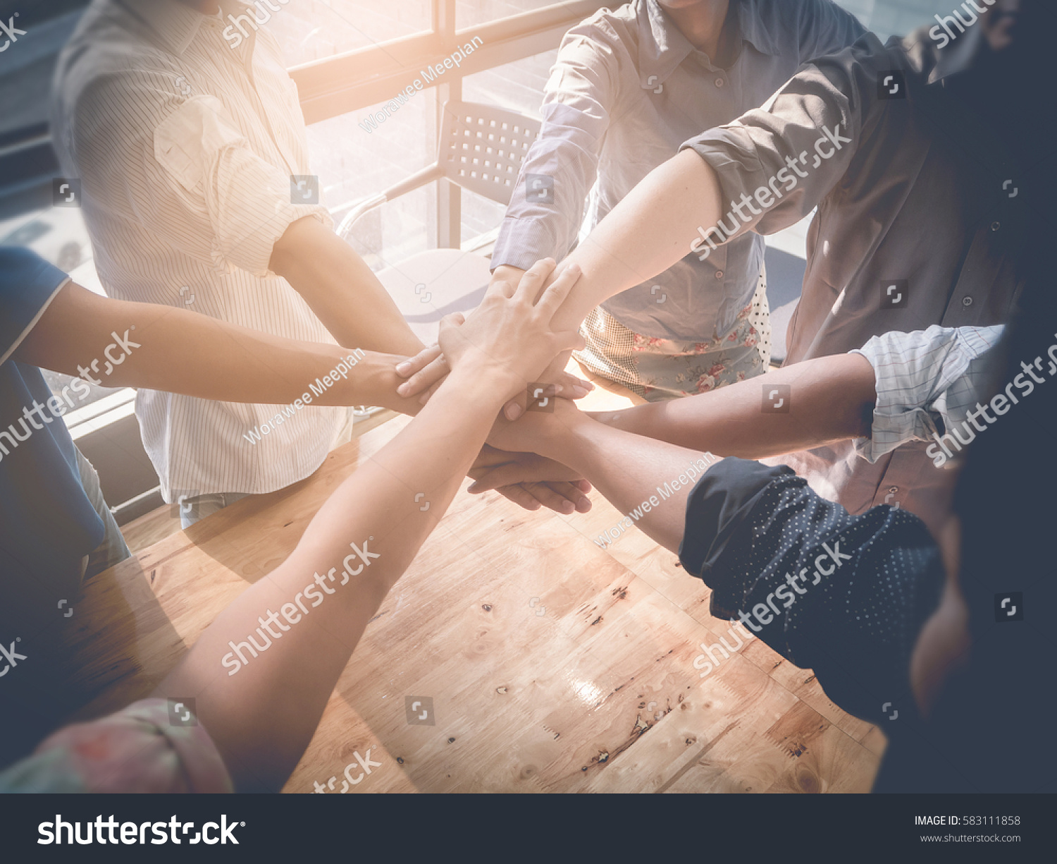 Group of Business people putting their hands working together on wooden background in office. group support teamwork cooperation concept. #583111858