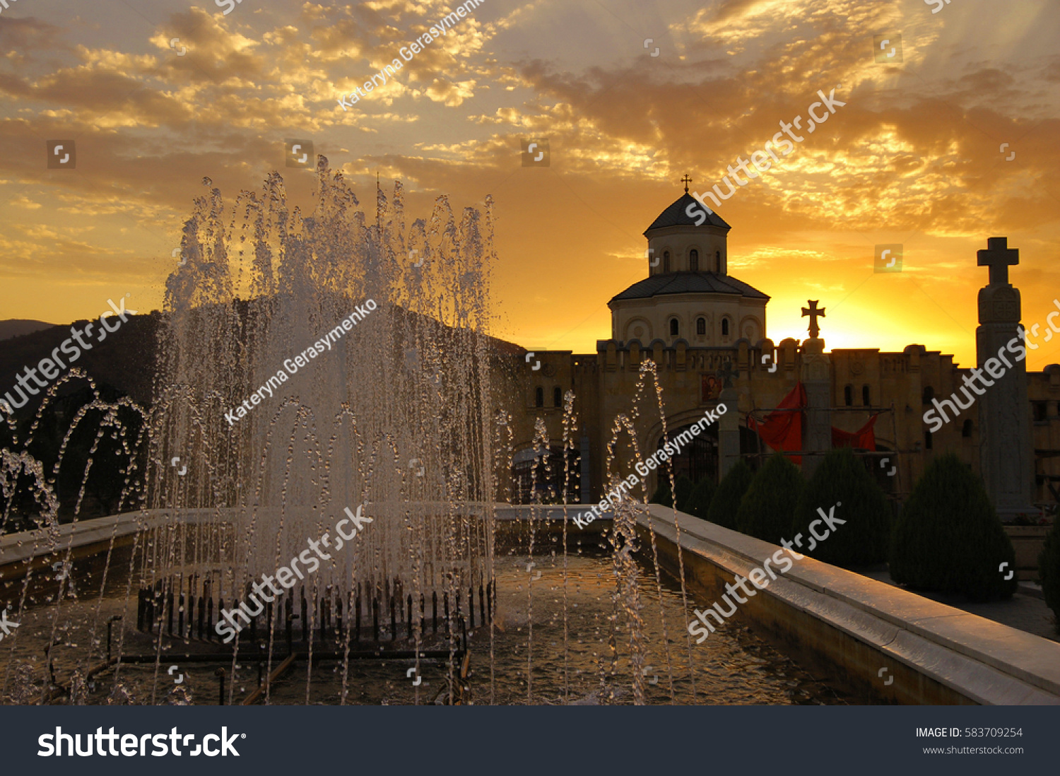 Fountain in the Holy Trinity Cathedral at sunset, Tbilisi, Georgia #583709254
