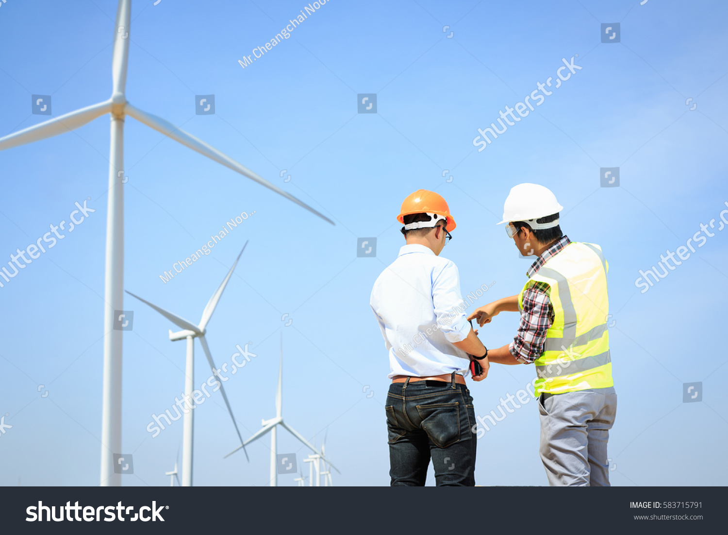 Engineers windmills for production of electric power. #583715791