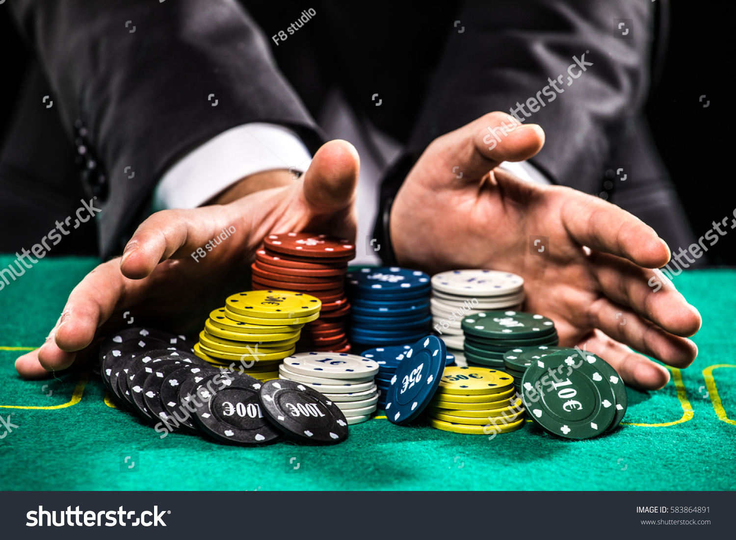 casino, gambling, poker, people and entertainment concept - close up of poker player with chips at green casino table #583864891