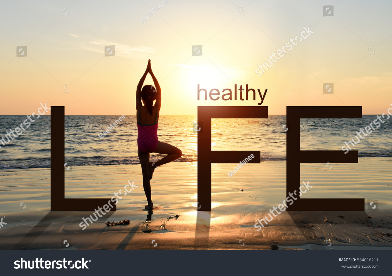  Silhouette of A girl practicing Yoga vrikshasana tree pose on tropical beach with sunset sky background, watching the sunset, standing as a part of the wording concept for healthy life.  #584016211