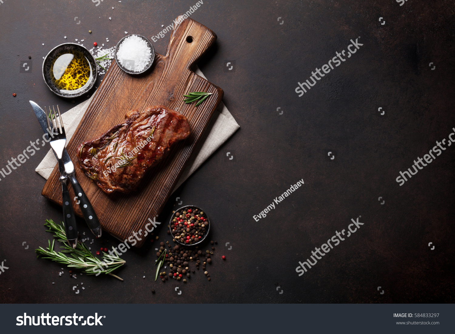 Grilled ribeye beef steak, herbs and spices. Top view with copy space for your text #584833297