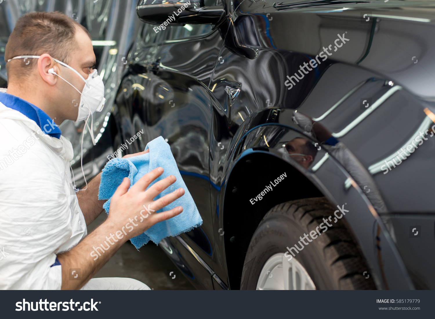 Man on a car wash polishing car with a polish machine #585179779