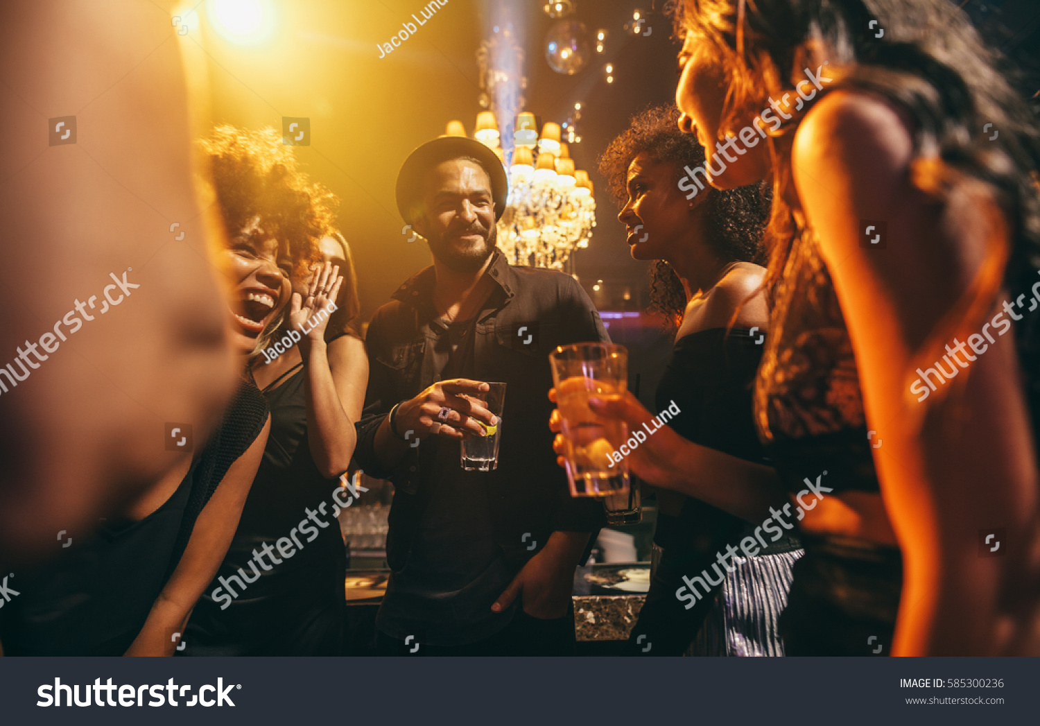 Image group of friends enjoying a party at pub. Happy young people having fun at nightclub. #585300236