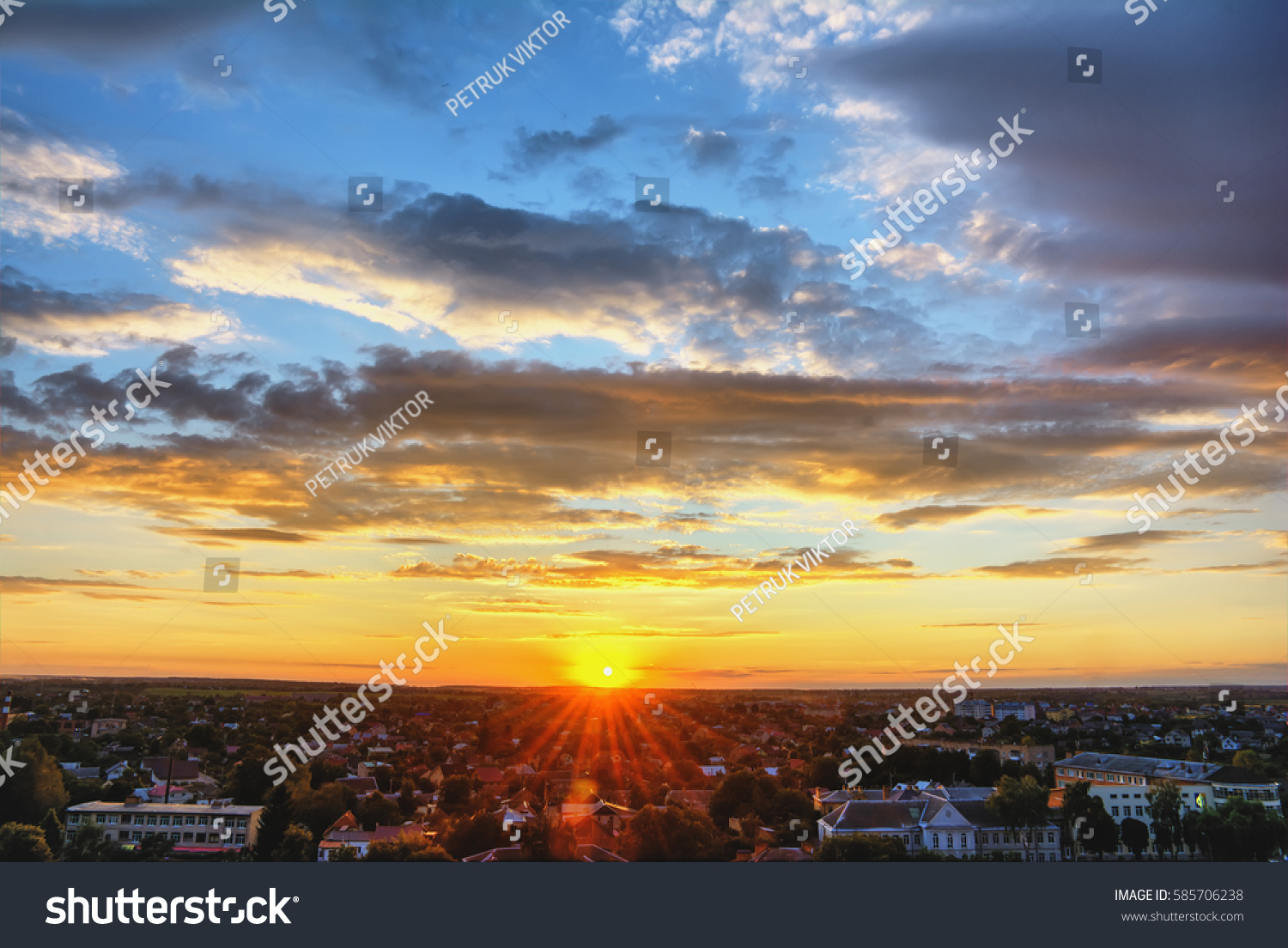 Sky and clouds at sunset over evening city. #585706238