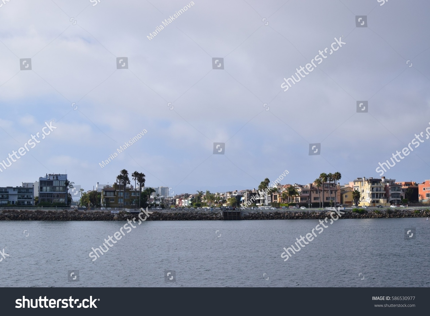 Sunny and cloudy day, houses and palm trees in bay area, California  #586530977