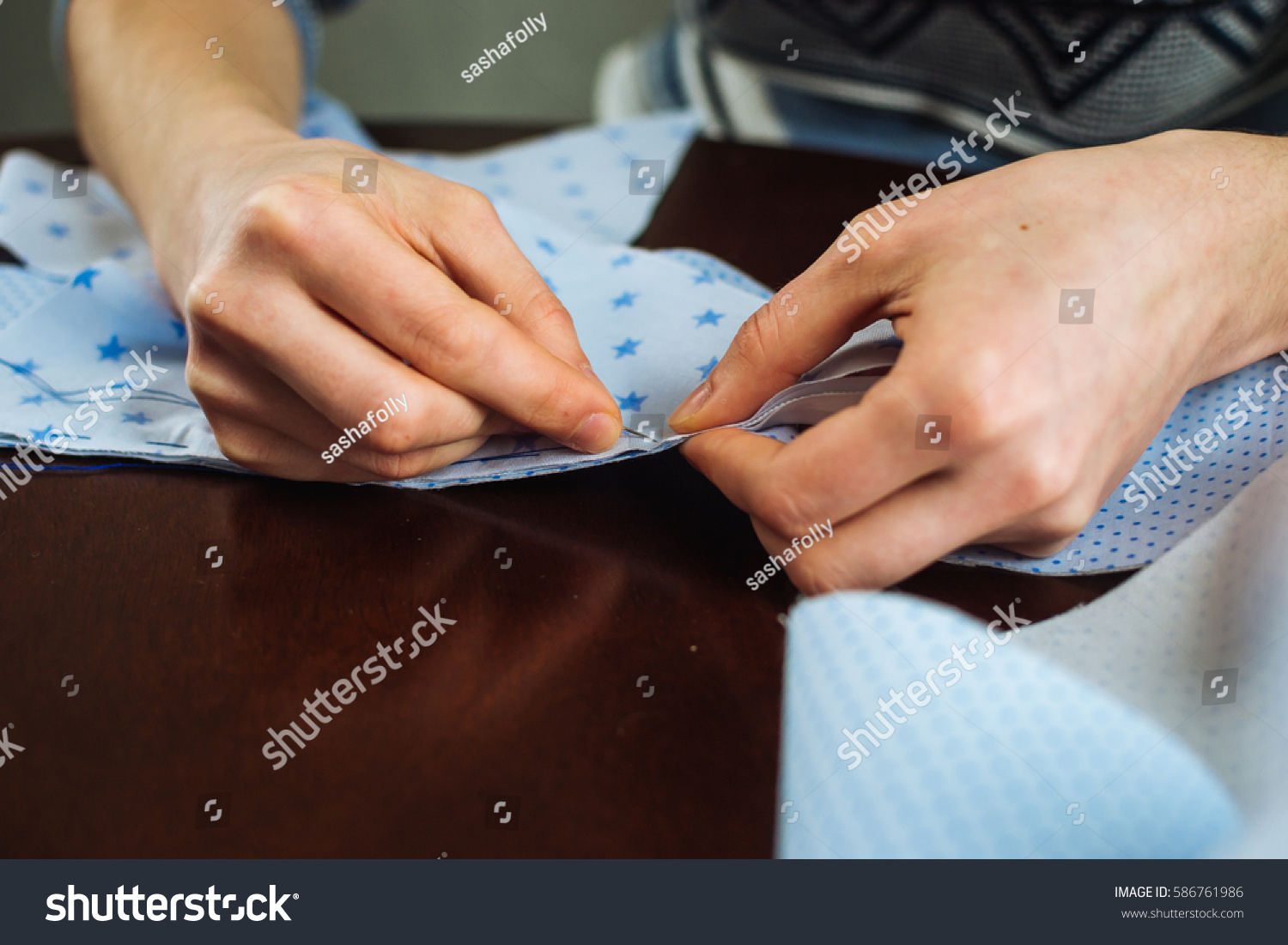 Close-up of woman's hand stitching quilting #586761986