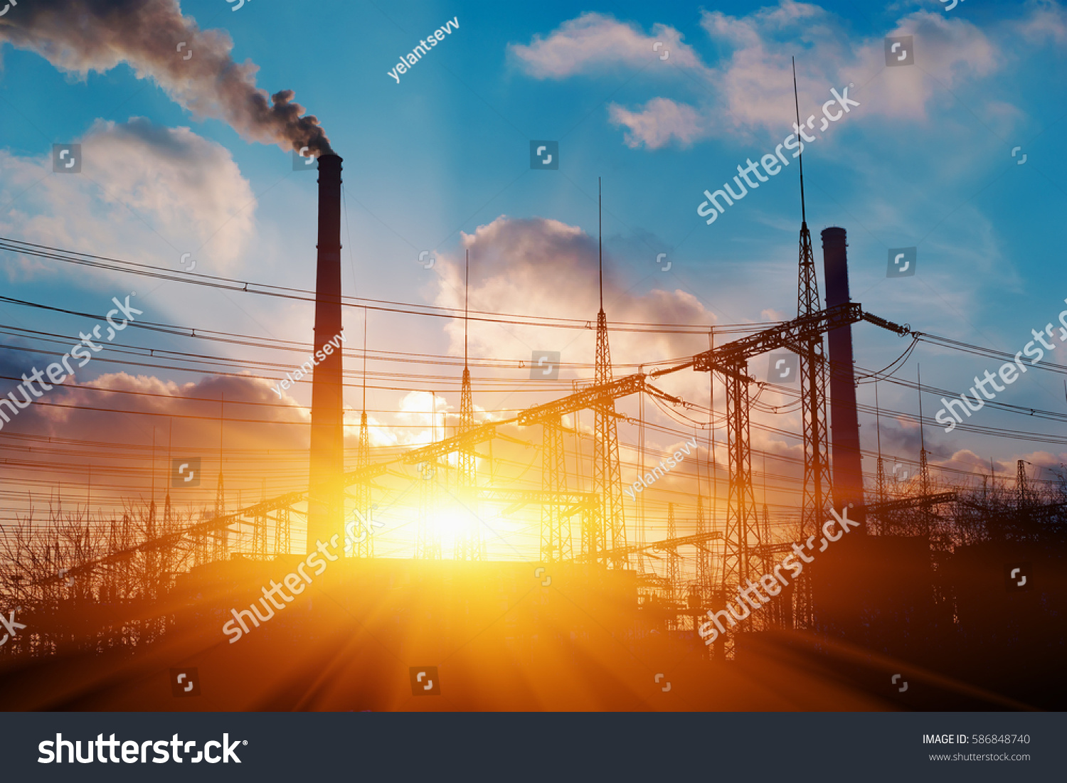 Thermal power stations and power lines during sunset #586848740