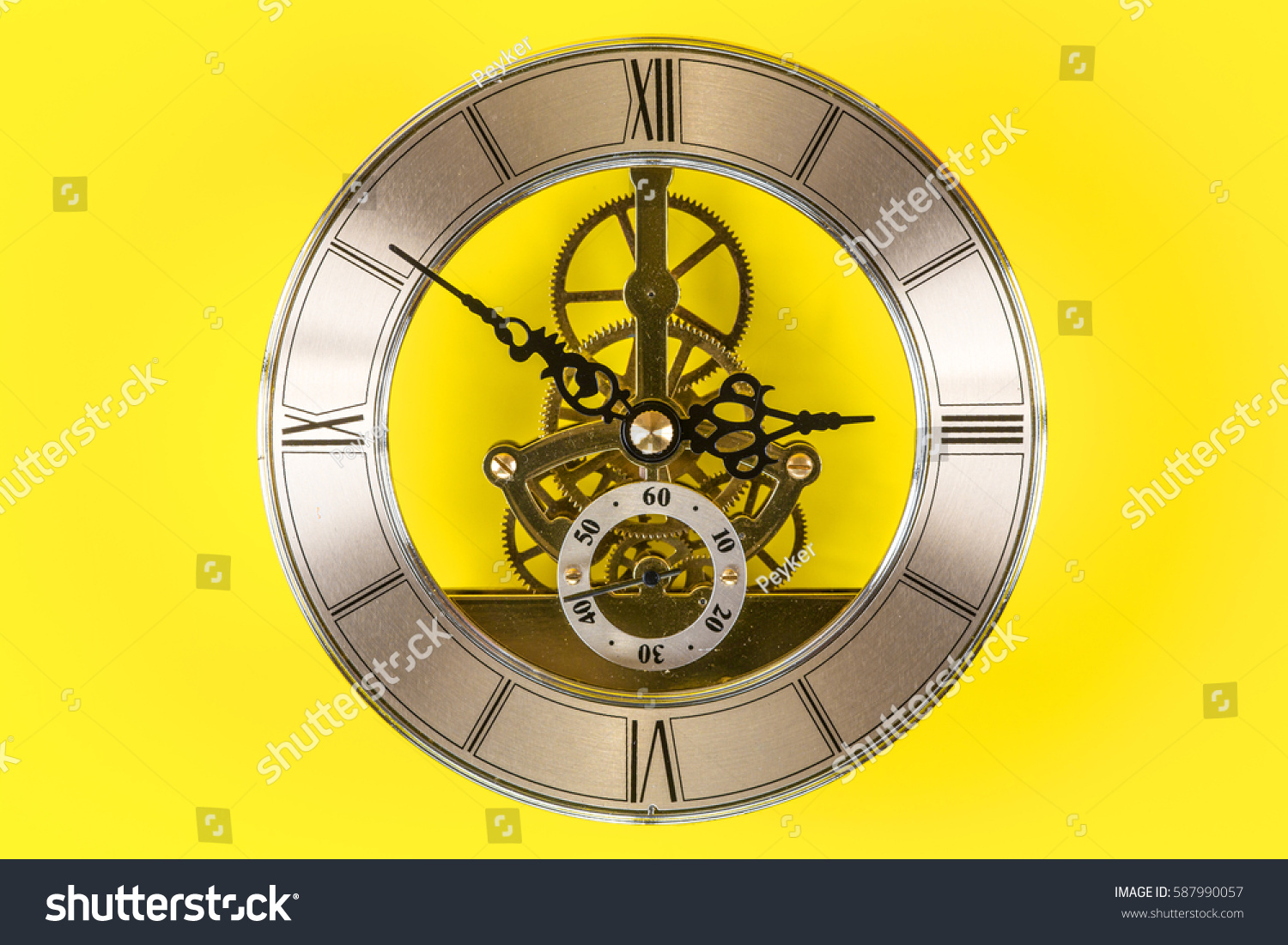 Vintage bronze clock isolated on a yellow background #587990057