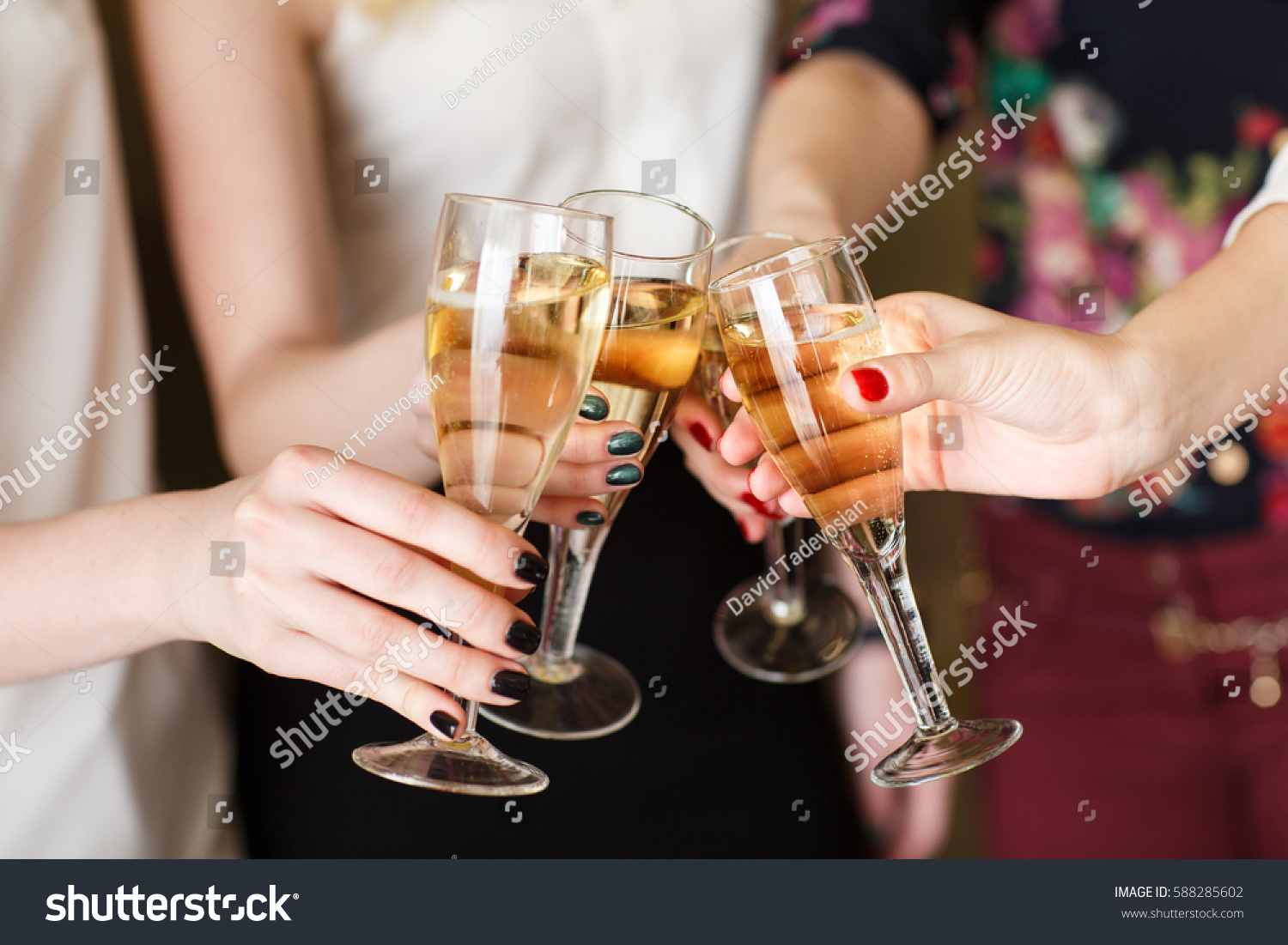 Hands holding the glasses of champagne making a toast #588285602
