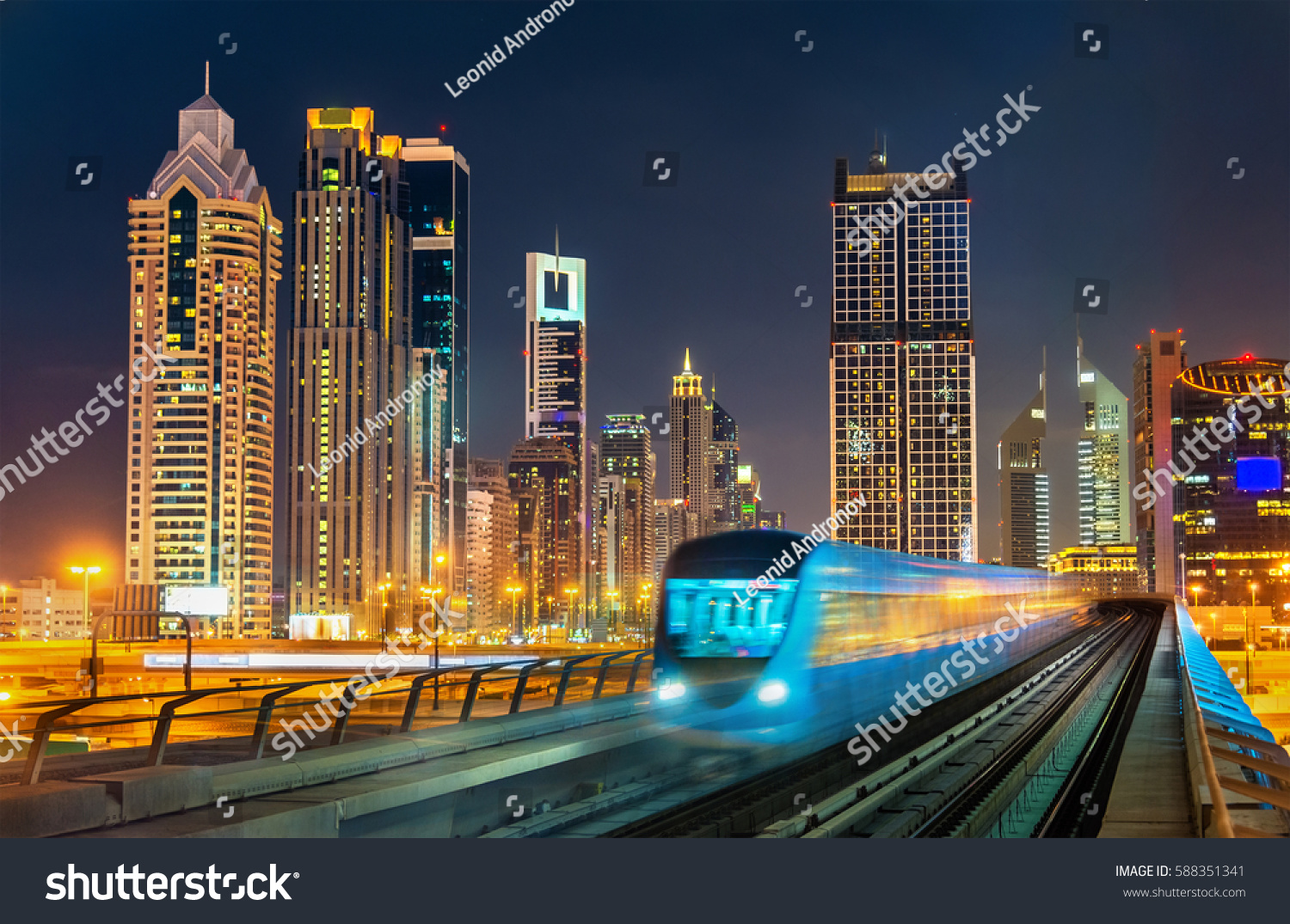 Driverless metro train with skyscrapers in the background - Dubai, the United Arab Emirates. #588351341