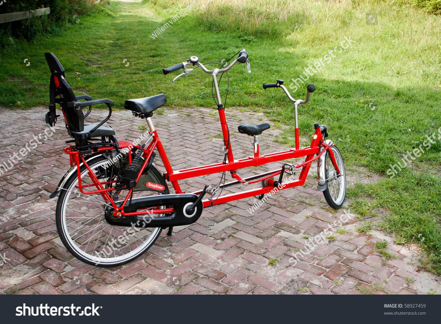 Red tandem bike with child's seat #58927459