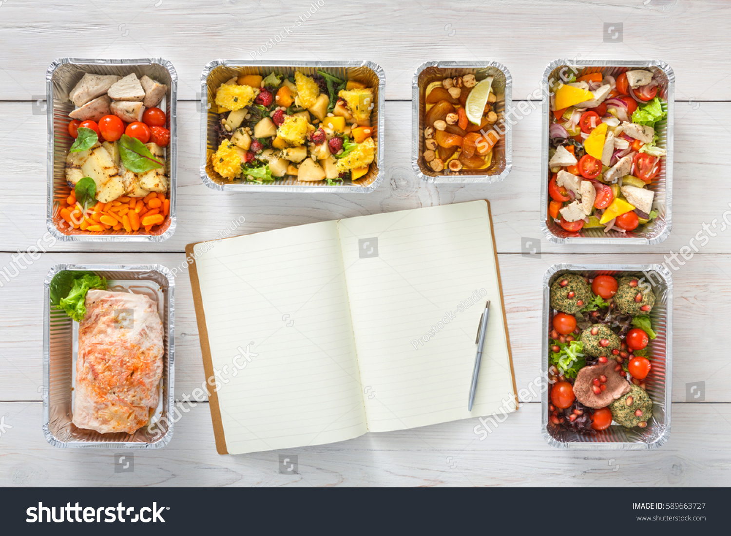 Diet plan mockup with healthy restaurant food delivery. Natural organic fitness nutrition for diet. Daily meals in foil boxes with copy space at white wood. Top view, flat lay #589663727