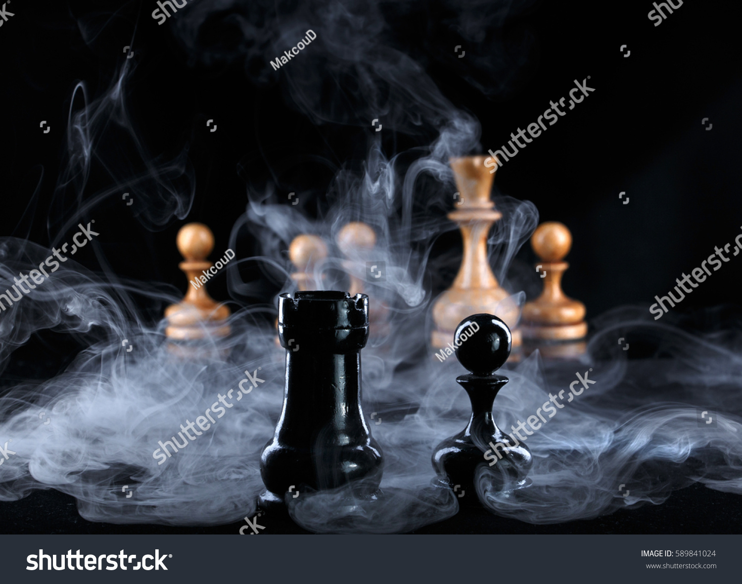 two black chess pieces in the fog opposite the white figures #589841024