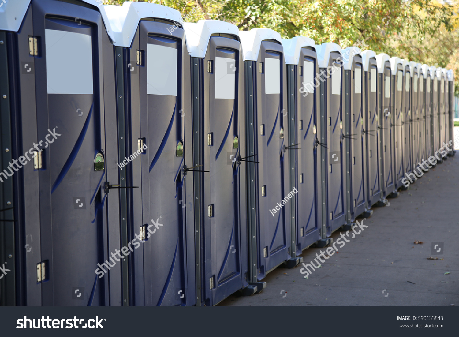 Row of portable toilets on a city street #590133848