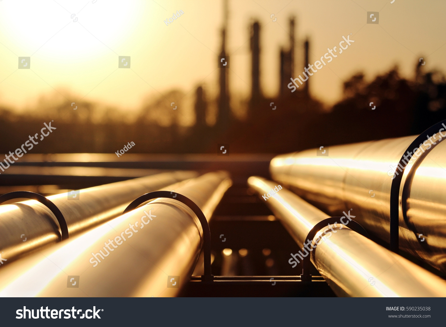 golden sunset in crude oil refinery with pipeline system #590235038