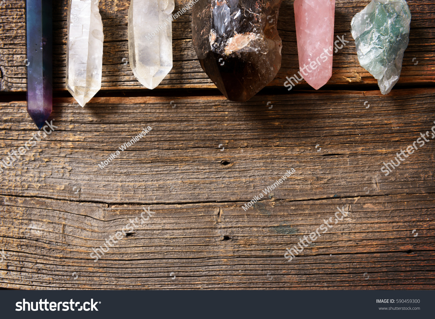 Multiple semi precious gemstones on wooden board
fluorite, quartz, smoky quartz, rose quartz.  #590459300