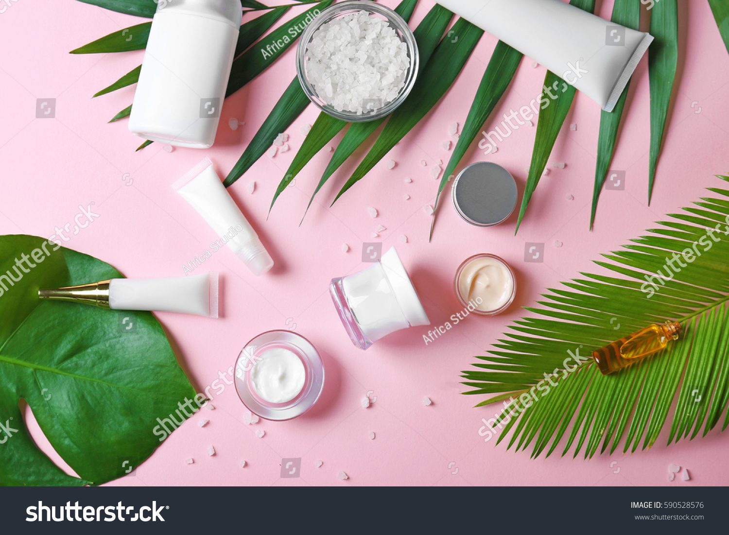 Natural cosmetics and leaves on pink background #590528576