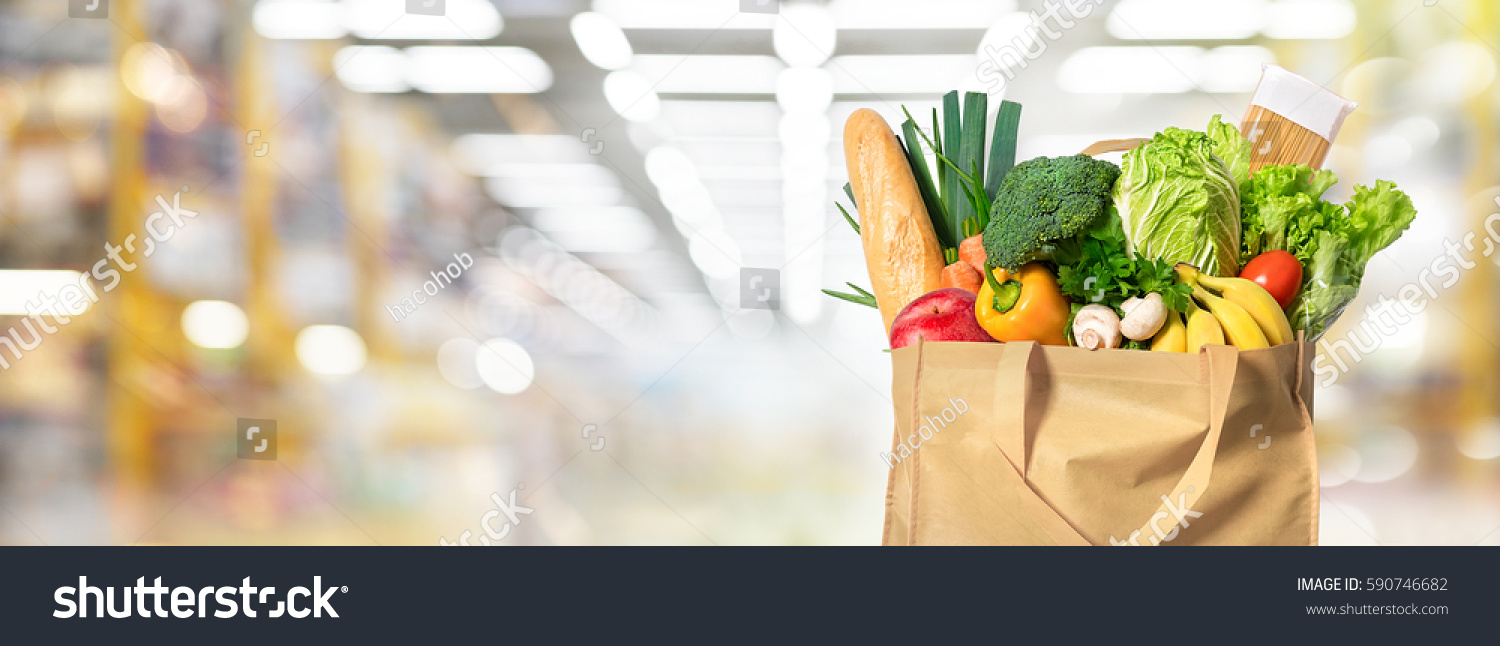 Eco friendly reusable shopping bag filled with vegetables on a blur background #590746682