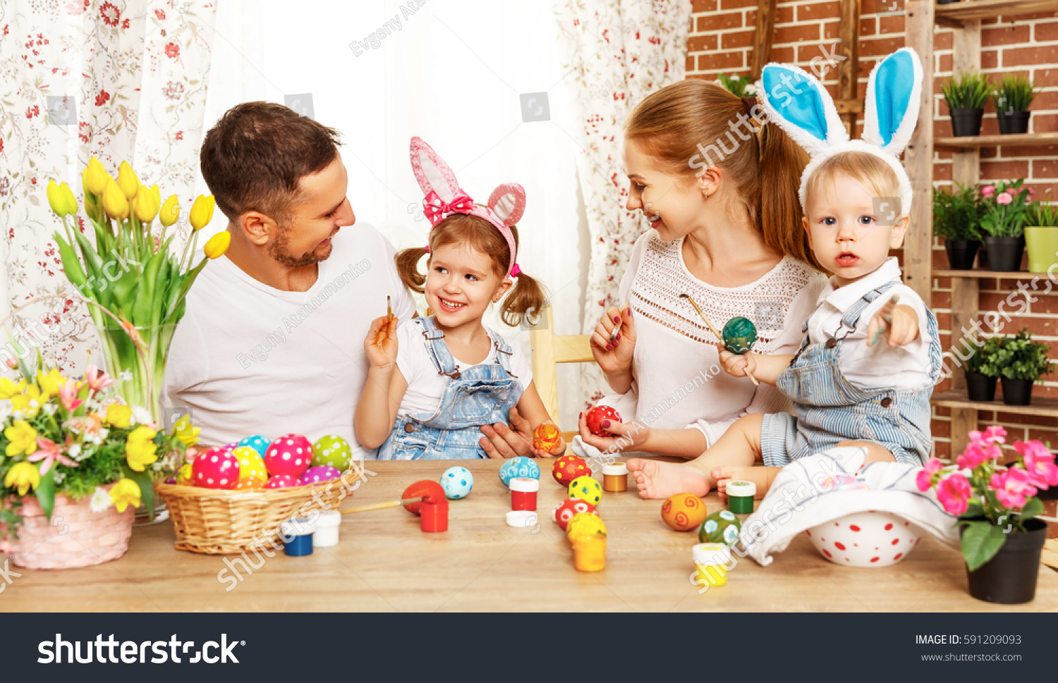 Happy easter! family mother, father and children having fun paint and decorate eggs for holiday
 #591209093