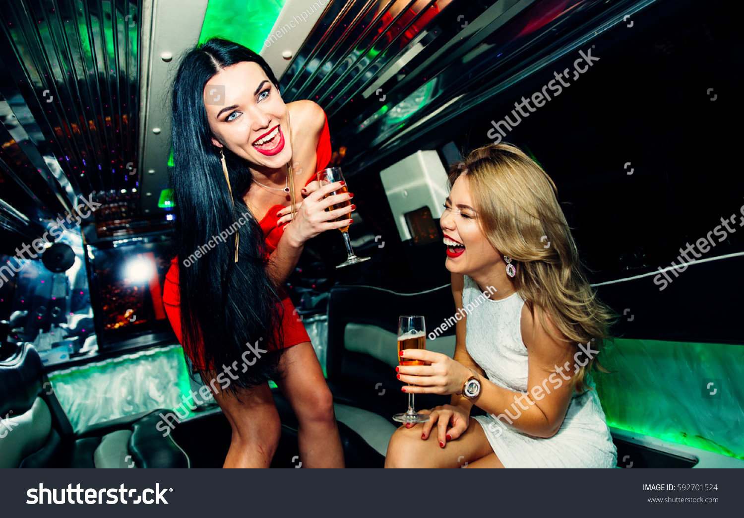 Beautiful girls making party in the limousine #592701524