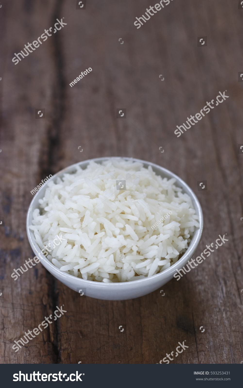 cooked rice with grain on wooden background.Thai jasmine rice. Steamed rice. #593253431