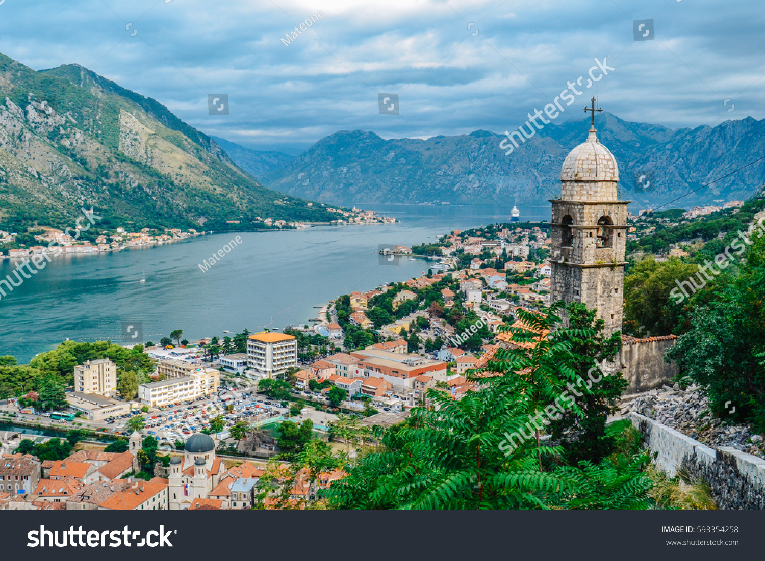 Panoramic view of town and mountains with church in foreground in Kotor, Montenegro #593354258