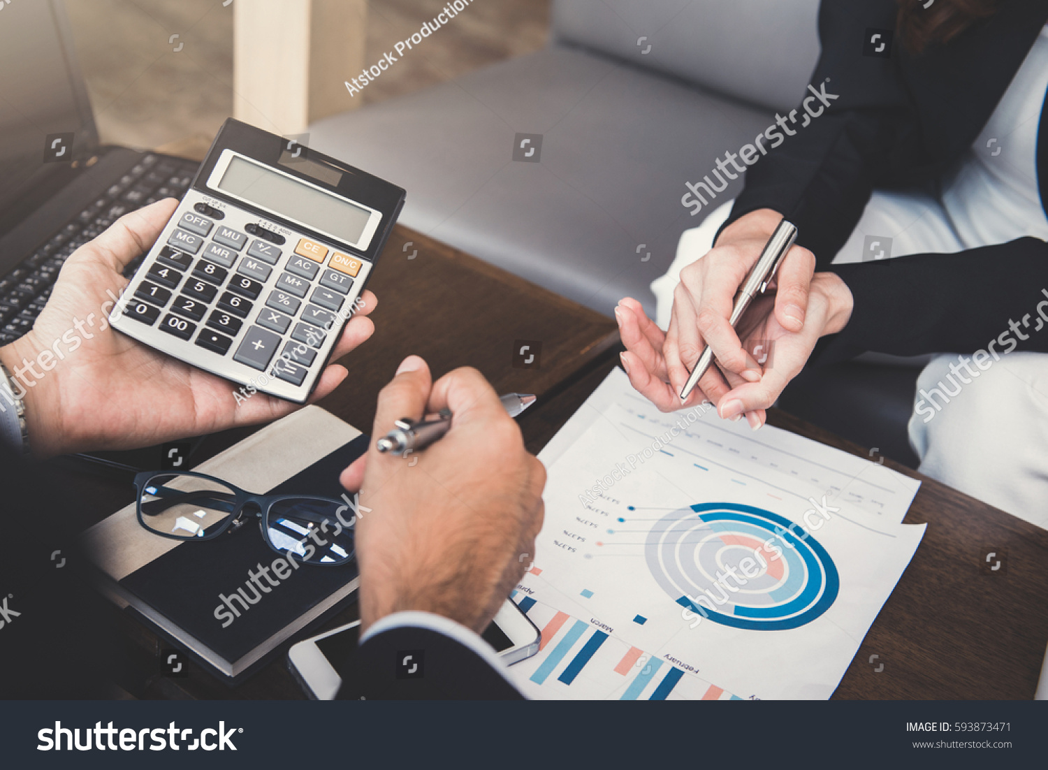 Financial adviser working with client, calculating and analyzing data at the table in cafe #593873471